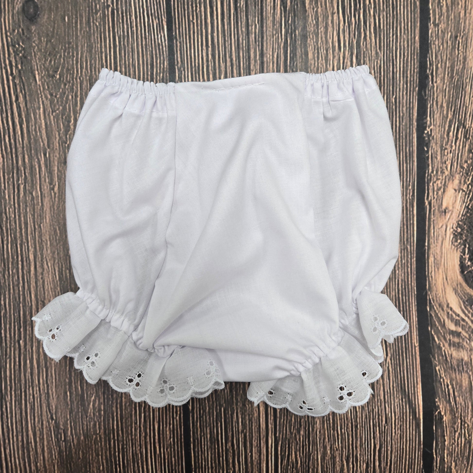 White lace shorts on a wooden surface