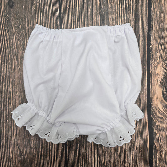 White lace shorts on a wooden surface
